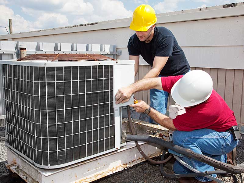 technicians-working-on-an-air-conditioner